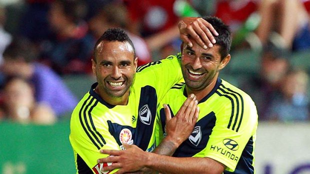 Archie Thompson and Carlos Hernandez celebrate a goal against Perth Glory.