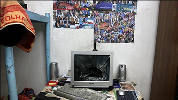 (Top) A broken computer monitor in a room in a Tehran University dormitory after it was attacked by militia forces during riots in Tehran on Monday and (bottom) the current website for the Iranian President Mahmoud Ahmadinejad.