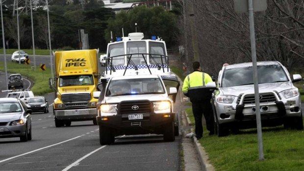 Water police make their point in Ballarat Road, Footscray, yesterday. A speed camera is in the 4WD parked by the road, and the police vehicle is in the way.