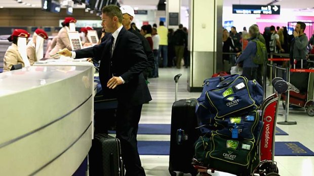 Michael Clarke checks in at Sydney International Airport on Sunday.