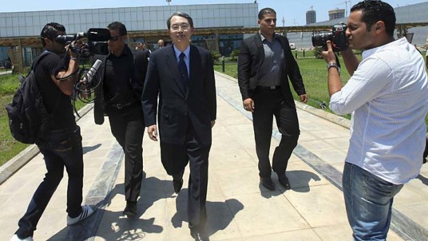 International Criminal Court president Song Sang-hyun arrives at Tripoli's international airport yesterday, ahead of the release of four staff members.