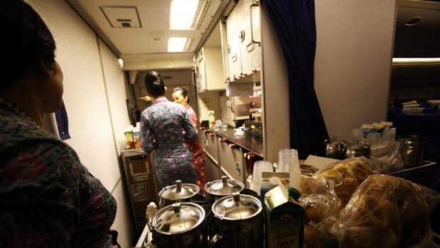 Cabin crew prepare to serve breakfast on MH318.