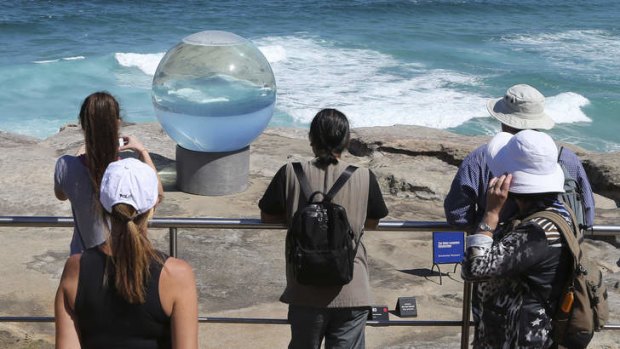 Visitors gaze at <i>Horizon</i> by Lucy Humphrey at the <i>Sculpture By The Sea</i> exhibition at Bondi.