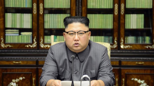 In a photo distributed on Friday, North Korean leader Kim Jong Un delivers a statement saying US President Donald Trump will "pay dearly" for his threats.