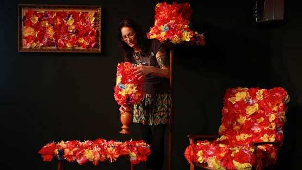 ''The colours are rich and sensual and scream Pacific'': Niki Hastings-McFall explores the contradictions of Pacific culture by lei bombing a living room artwork with the bright flowers.