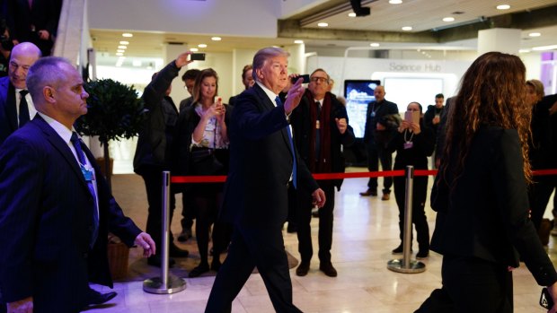 President Donald Trump waves as he walks to a dinner with European business leaders at the World Economic Forum in Davos on Thursday.