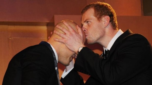 Another kind of contact: Adam Cooney presents Gary Ablett the Brownlow in 2009.