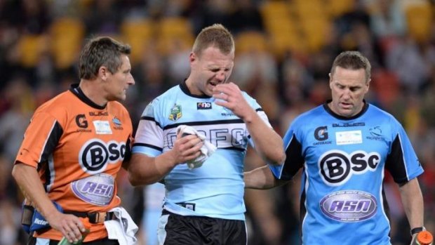 Bad Luke: Sharks forward Luke Lewis has a facial wound attended to.
