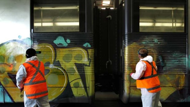 Spray it again ... RailCorp's Sean McQuarrie, left, and Kevin Rowe get to work cleaning Hornsby station. In the 2009-2010 financial year, the clean-up bill was $55 million.