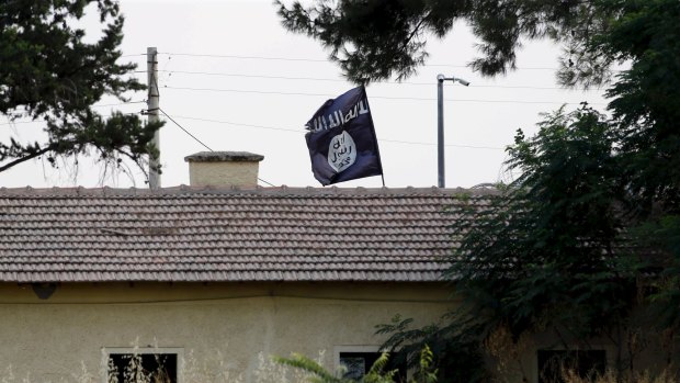An Islamic State flag flies over the custom office of Syria's Jarablus border gate, pictured from the Turkish town of Karkamis.