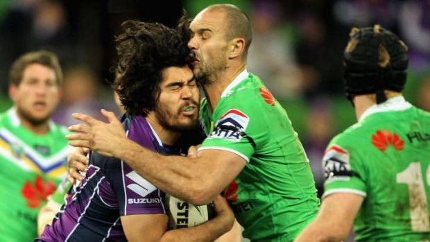 Head clash: Melbourne forward Tohu Harris and Raiders prop Dane Tilse meet in the middle.