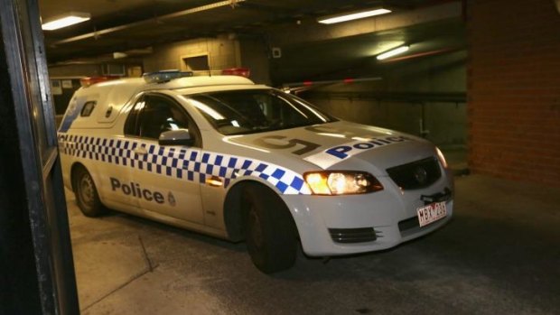 A police car leaves St Kilda Road Police Complex with Hewat on Thursday morning.