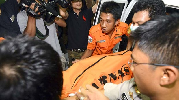 An Indonesian rescue team carries the body believed to be of a missing Japanese scuba diver.