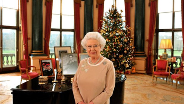 Head of the Commonwealth Queen Elizabeth II stands in the Music Room of Buckingham Palace.