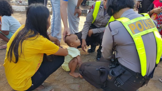 Former members of the Gafatar sect with police at a temporary evacuation camp in Pontianak, West Kalimantan. 