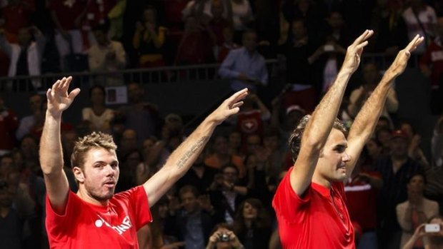 Switzerland's Stanislas Wawrinka and Roger Federer celebrate.