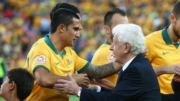 Trophy time: Frank Lowy with Socceroos star Tim Cahill at the 2015 Asian Cup final in Sydney.