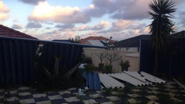 Monday morning's storm left a fence down at this house in  Perth's northern suburbs.
