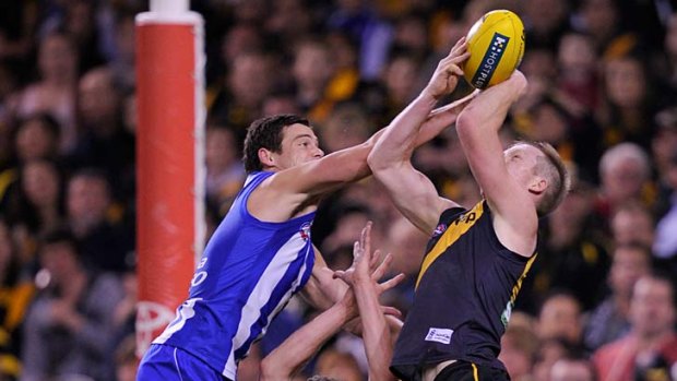 Tiger take: Jack Riewoldt marks over Tyrone Vickery and North's Nathan Grima.