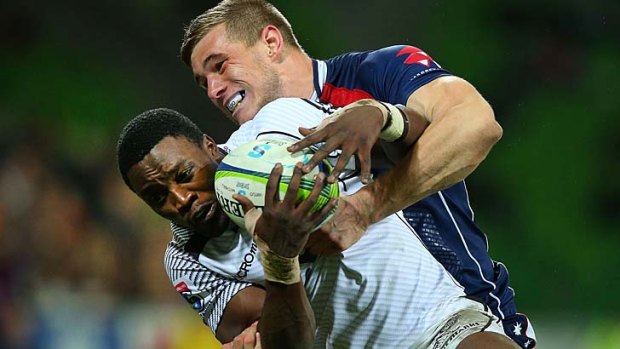 Under the pump: Sharks player Lwazi Mvovo is tackled by Melbourne's Jason Woodward.