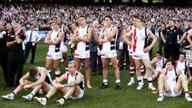 St Kilda players and staff watch as the Magpies accept their premiership medallions yesterday. The Saints have failed to win any of the five grand finals they have played in since they won their only flag in 1966. But the players maintain they will ''suck it up and go again'' next year.