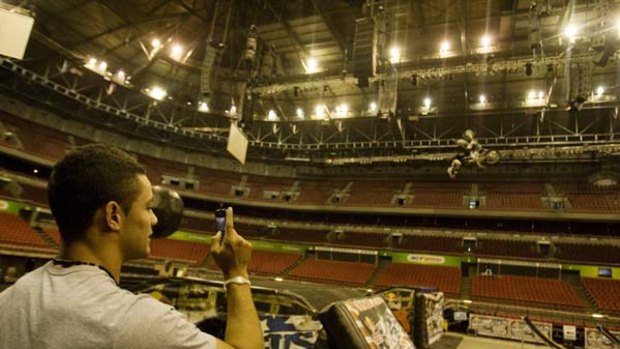 Is it a bird? ... a rider from Nitro Circus Live practises at Acer Arena as Parramatta's Jarryd Hayne takes a snapshot on his mobile phone.