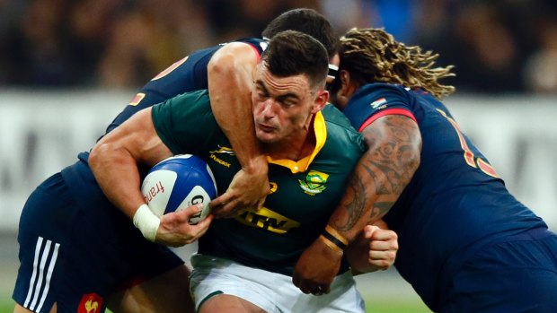 Sandwiched: Jesse Kriel of South Africa is tackled by France's Geoffrey Doumayrou, left, and Mathieu Bastareaud.