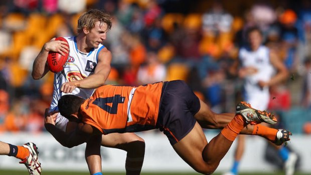 Hard hit ... Israel Folau of the Giants tackles Trent McKenzie.