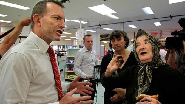 Tony Abbott speaks to Stanka Baltoska during his visit to the Queanbeyan Fresh Food Market yesterday.