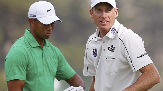 Tiger Woods slips down in contention as Jim Furyk maintains his lead.