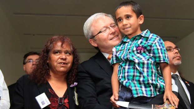Many happy returns &#8230; Kevin Rudd with a young fan at a morning tea at Parliament House to mark the fourth anniversary of the stolen generation's apology.