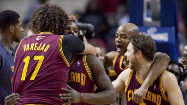 Cleveland Cavaliers guard Dion Waiters is hugged by teammate Anderson Varejao after sinking a two-pointer to defeat the Detroit Pistons 97-96 as Jarrett Jack and Matthew Dellavedova celebrate.