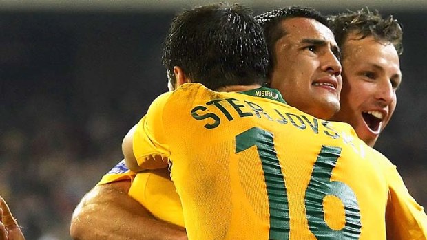 Happy times ... Tim Cahill of the Socceroos celebrates his second goal with Mile Sterjovski and Lucas Neil when Australia last hosted Japan in a World Cup qualifier in Sydney, 2010.
