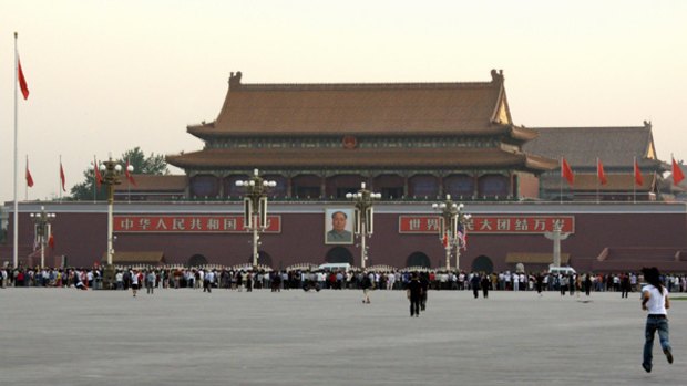 Members of the public watch the flag raising ceremony in Tiananmen Square.