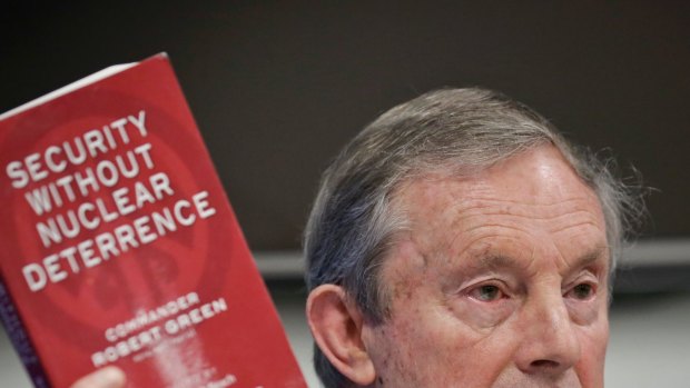 Former UK naval commander Rob Green holds his book while discussing a new treaty to ban nuclear weapons on Wednesday.