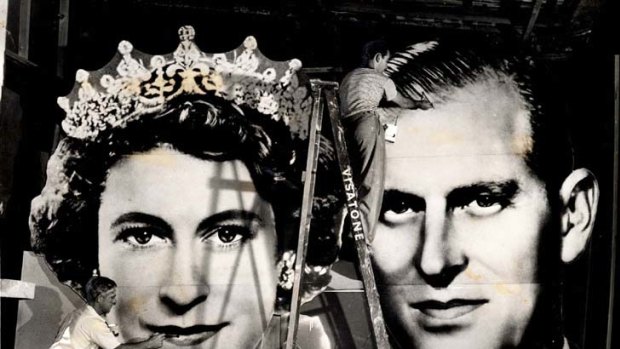 The way they were ... workers prepare a billboard of the royal couple.