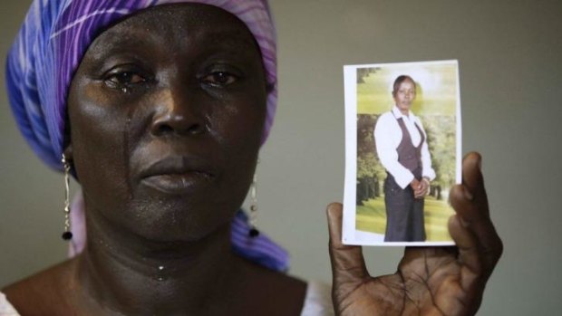 Missing: Martha Mark with a picture of her daughter Monica, one of the 276 girls abducted by Boko Haram in mid-April.