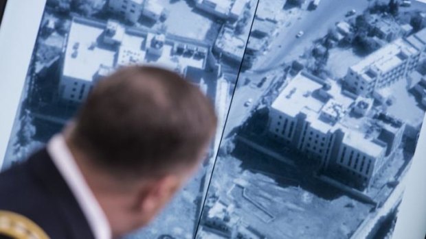 Lieutenant General William C. Mayville shows before and after photos of the airstrikes in Syria during a briefing at the Pentagon.