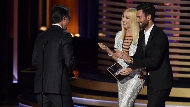 Woops: Gwen Stefani and Adam Levine present Stephen Colbert with his Emmy.