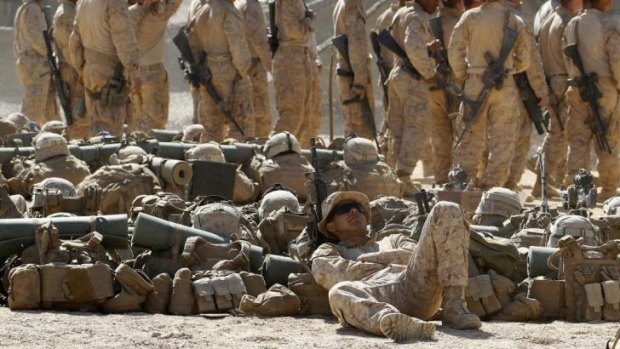 Costly: US personnel wait to begin a training exercise in Jordan in 2013. The rising costs of personnel have forced the Pentagon to make hard choices.