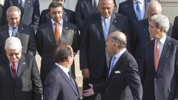 John Kerry (front right) coalition building in Paris with  French and Iraq leaders.