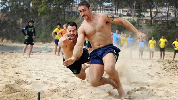 Photo finish ... Tom Learoyd-Lahrs beats David Shillington in a beach flags contest yesterday. Canberra were at Batemans Bay for a pre-season camp.
