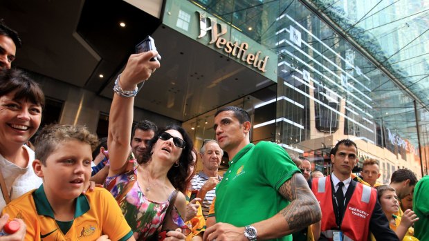 Snap-happy: Tim Cahill with fans at Martin Place on Sunday morning. 
