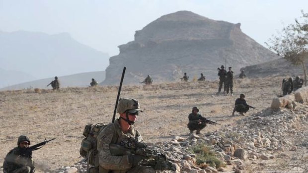 Australian soldier Corporal Dan Miller, Mentoring Task Force Three, props down alongside soldiers from the Afghan National Army during a clearance patrol in the Mirabad Valley, Afghanistan.