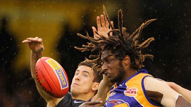 Flying: Nic Naitanui does battle with Carlton's Jordan Russell.