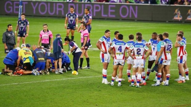 Newcastle Knights players in a huddle after Alex McKinnon's devastating injury.
