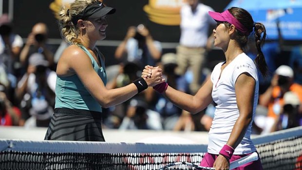 Li Na of China, right,  shakes hands with Canadian Eugenie Bouchard.