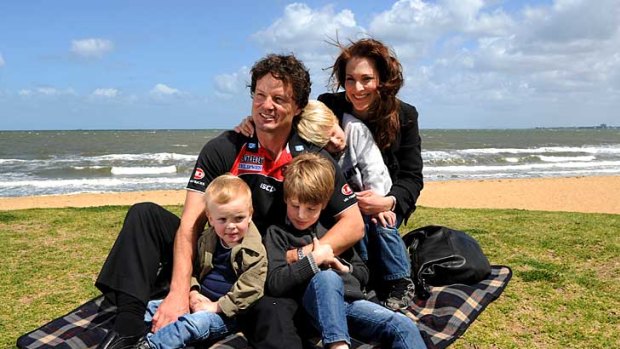 Scott Watters, wife Emily and sons Oliver, Joshua and Sebastian visit St Kilda beach today.