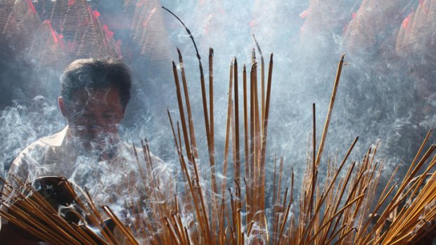 Locals burning incense during Vietnamese lunar New Year celebrations.