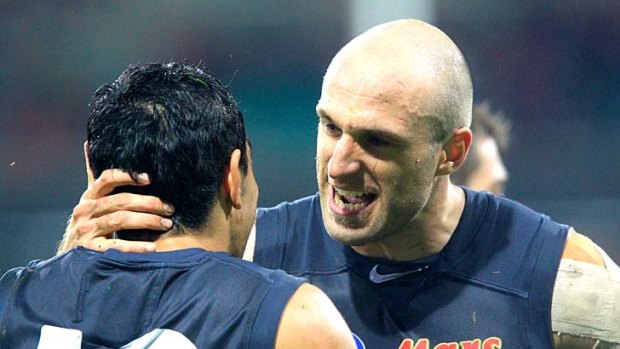Chris Judd, right, happy to beat the Swans at the SCG, with Eddie Betts.
